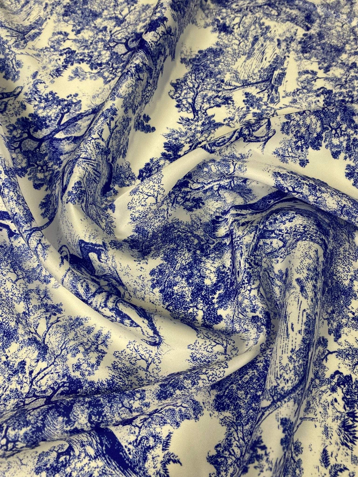 Blue fabric with detailed wild forest pattern design for sewing and crafts