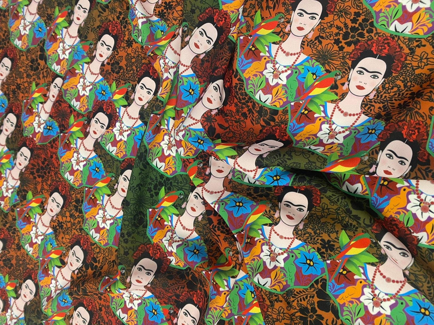 Colorful Frida Kahlo inspired floral print fabric with vibrant flowers and portrait motifs on fabric with 150cm width