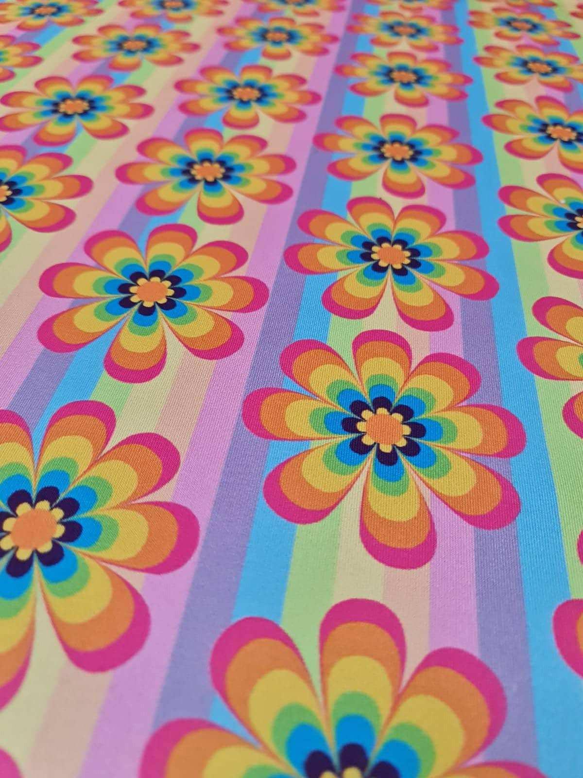 colorful rainbow floral fabric with vibrant flower patterns and striped background