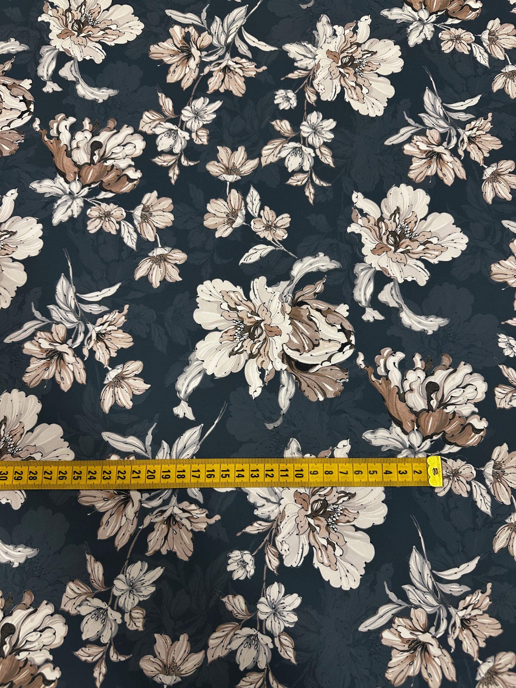 Vintage floral fabric with beige and white flowers on a dark background measuring 150cm wide