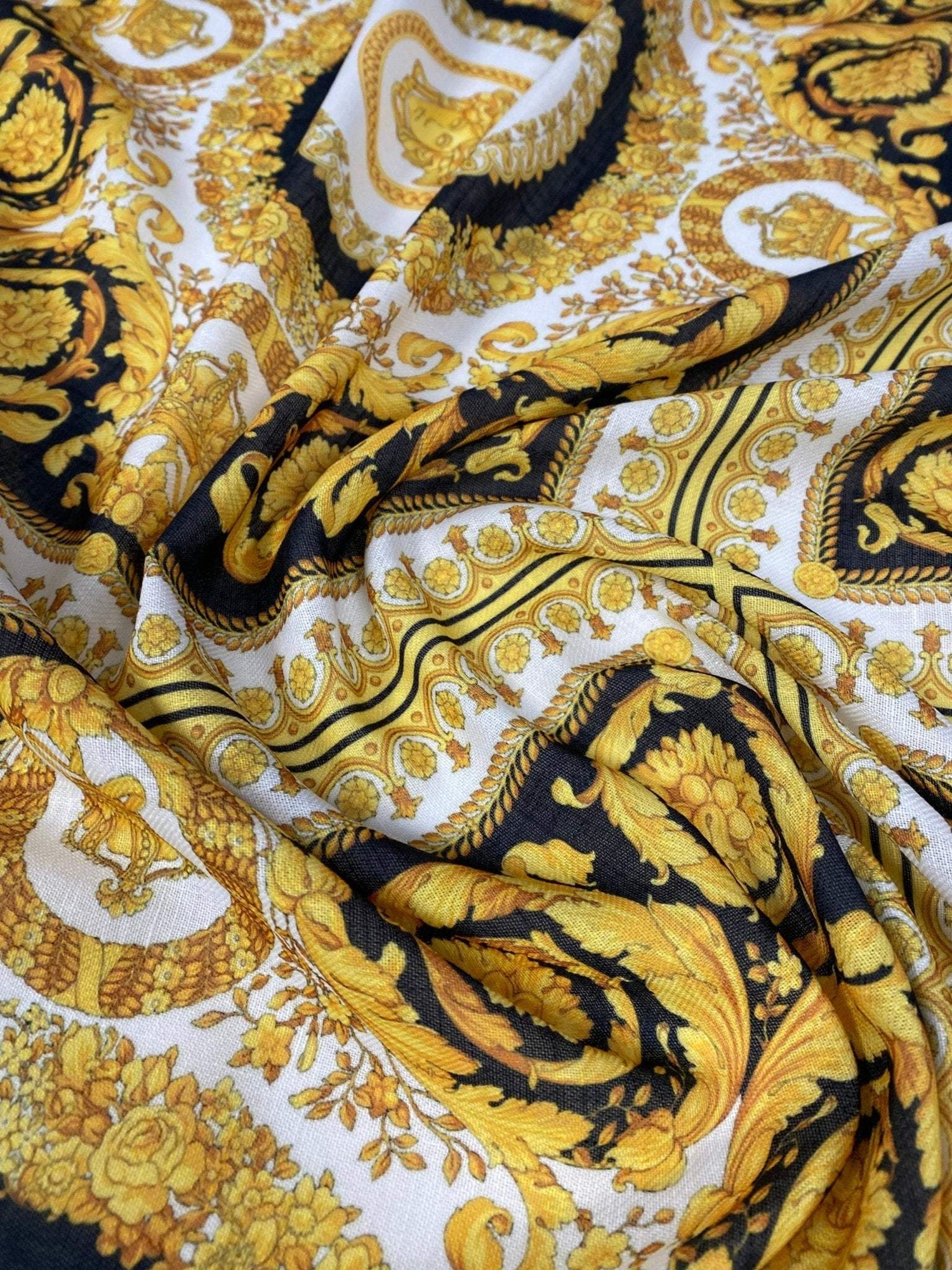 Luxurious Baroque Medusa pattern fabric in black and gold with intricate ornate design and rich colors