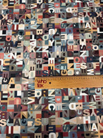 Colorful modern alphabet pattern fabric with varied typography design and ruler for scale