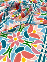 Colorful mosaic floral fabric with pink, blue, green, and yellow pattern, perfect for sewing and quilting projects