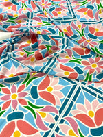 Colorful mosaic floral fabric with pink, blue, and green pattern, ideal for quilting and home decor projects.
