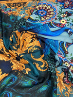Vintage peacock pattern fabric with vibrant blue and gold intricate designs for sewing and upholstery projects