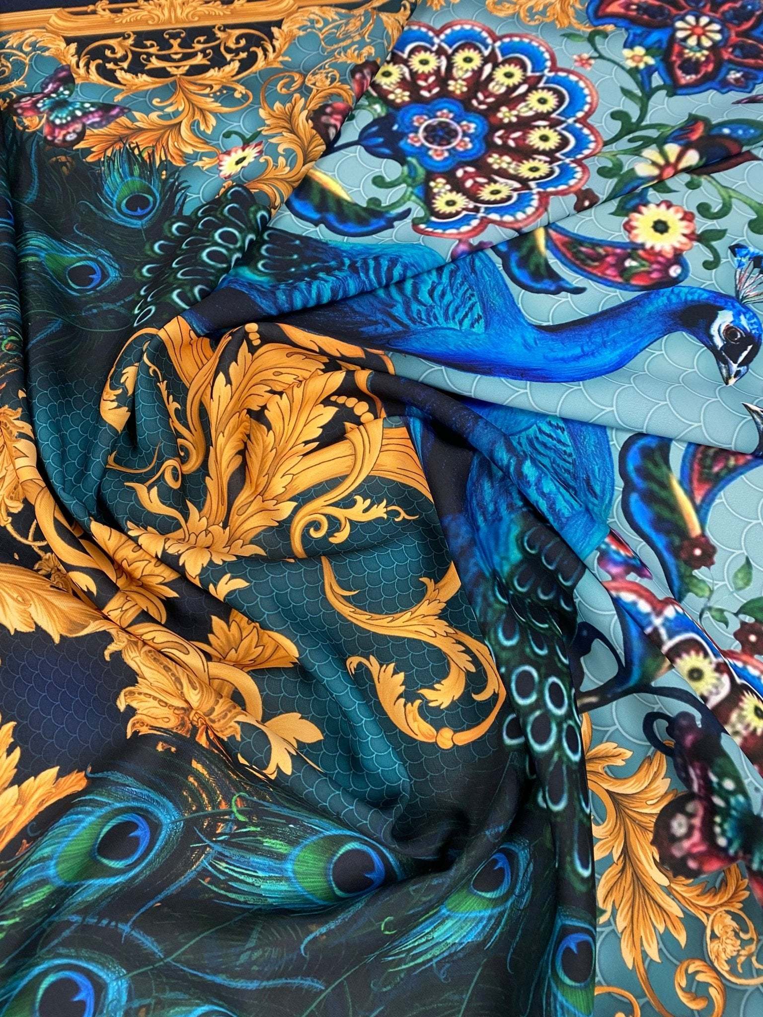 Vintage peacock pattern fabric with vibrant blue and gold intricate designs for sewing and upholstery projects