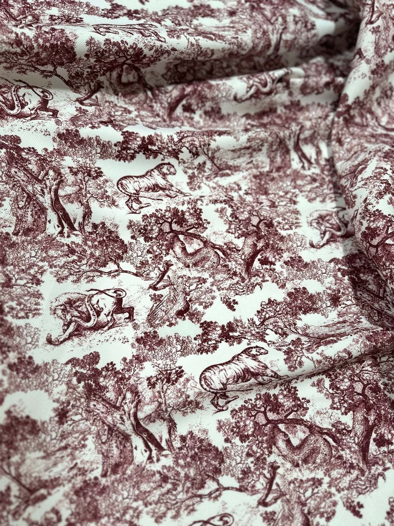 Brown wild forest pattern fabric with white animal illustrations and tree designs, 150cm wide textile for sewing projects and home decor.